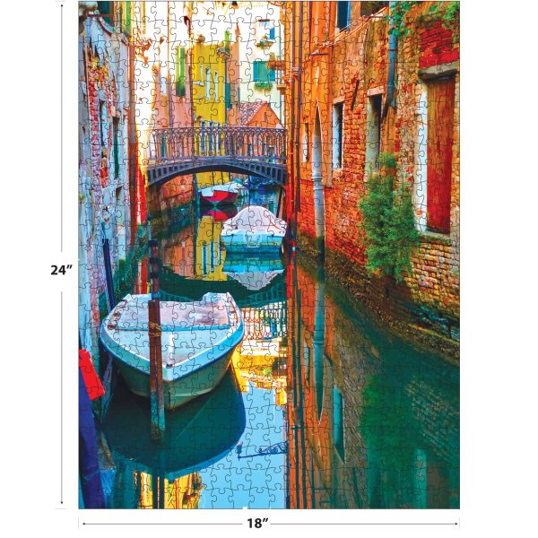 A completed 24x18 inch RoseArt - KODAK Supreme - Pretty Canal with Small Bridge and Motorboats - 550 Piece Jigsaw Puzzle.