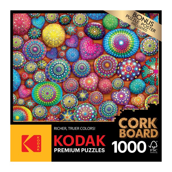 A RoseArt - Kodak Cork - Mandala Stones - 1000 Piece Jigsaw Puzzle depicting a colorful array of intricate mandala designs on a corkboard background. The box mentions a bonus puzzle poster included.
